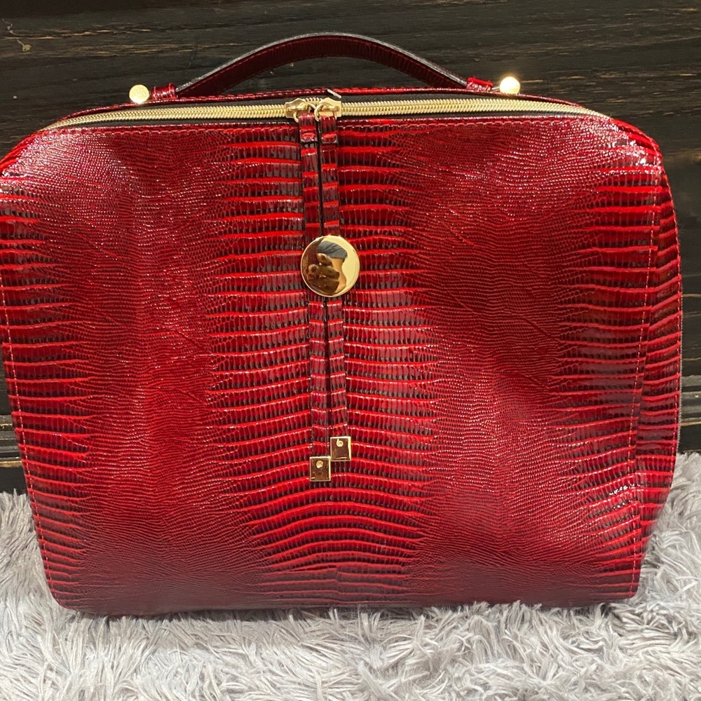 Estée Lauder faux leather textured makeup bag.